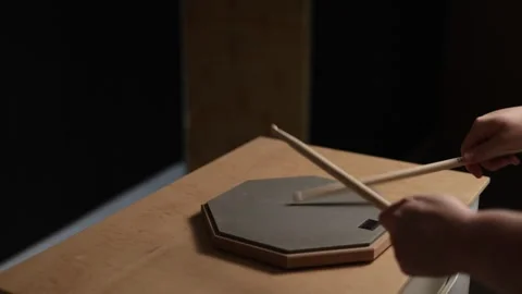Close-up of hands practicing drumming on a practice pad with sticks Vidéo 341737460