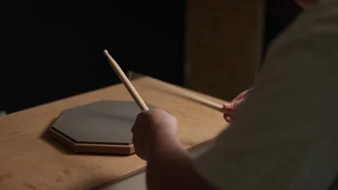 Close-up of hands practicing drumming on a practice pad with sticks Vidéo 341737484