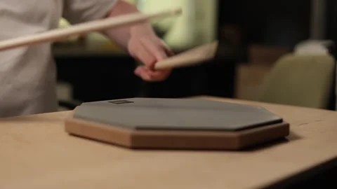 Close-up of hands practicing drumming on a practice pad with sticks Video stock 341737596