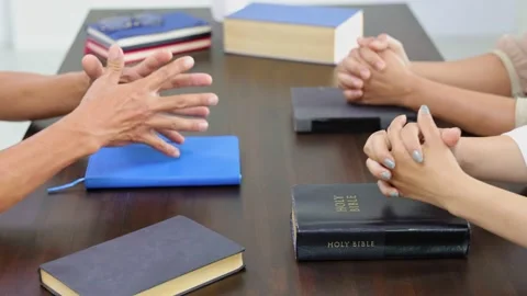 Close up hands praying on Bible at home, church in home, devotional or prayer Stock Footage 201660063