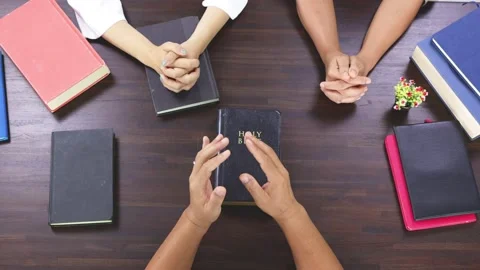 Close up hands praying on Bible at home, church in home, devotional or prayer Stock Footage 201660076