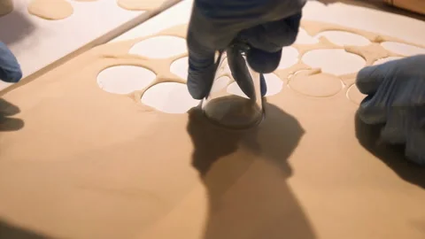 Close-up of hands preparing dough for dumplings. The production process of Stock-Footage 94959301