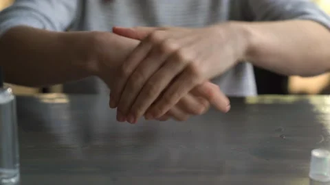 Close Up Of Hands Preparing Hygienically with an Antiseptic Hand Rub Stock Footage 153654168