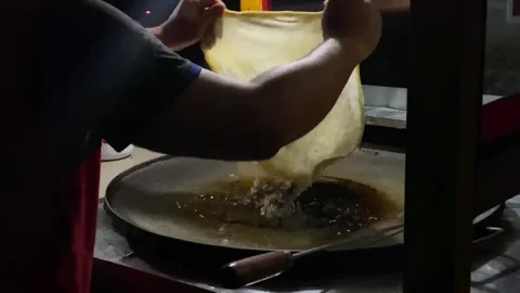 Close-up of hands preparing martabak  Stock Footage 292908852