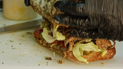 Close up of hands preparing roast beef sandwich Stock Footage 94457192