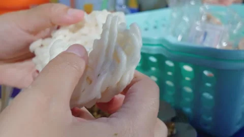 Close up of hands preparing traditional crispy snack food item in kitchen. Video stock 343417309