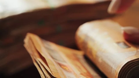 Close-up hands presenting euro banknotes, signifying wealth, financial planning. Stock-Footage 335140430