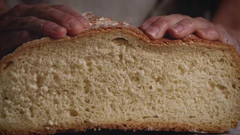 Close up of hands that press a traditional bread. Healthy, natural food for meal Stock Footage 147939261