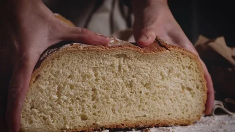 Close up of hands that press a traditional bread. Healthy, natural food for meal Stock Footage 147939263