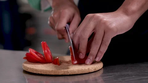 Close-up hands of professional chef chopping vegetable tomatoes by knife on.. Stock Footage 245080381