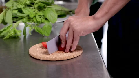 Close-up hands of professional chef chopping vegetable tomatoes by knife on.. Stock-Footage 245129376