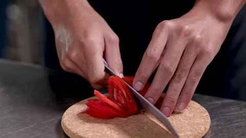 Close-up hands of professional chef chopping vegetable tomatoes by knife on.. Stock Footage 245130049