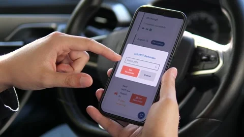 Close-up of hands programming a future maintenance alert into a car management Video stock 316584790
