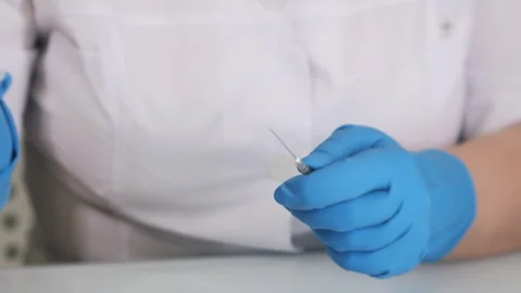 Close up of hands in protective gloves taking a syringe. Stock Footage 302172676