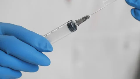 Close up of hands in protective gloves taking a syringe. Stock Footage 302178474