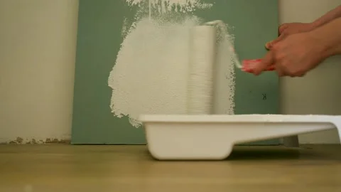 Close up of hands in protective work gloves painting wall with white colour 動画素材 139716751