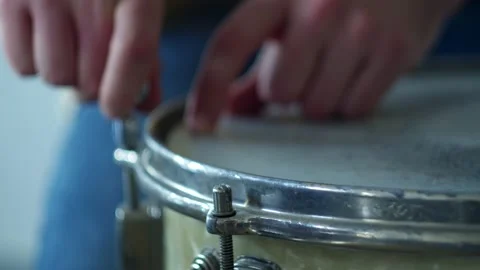 Close-up hands pull up the key, set up the drum Stock Footage 156256730