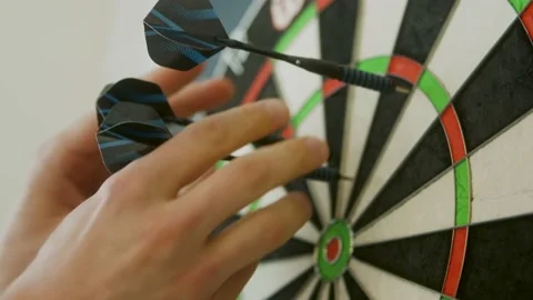 Close up hands pull out three darts out of the dartboard Stock Footage 203897355