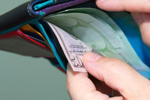 Close up of hands pulling  banknotes 50 dollar out of wallet Stock Photos