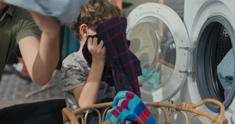 Close-up of hands pulling clothes from a wicker basket. A child packs things Stock Footage 200841809