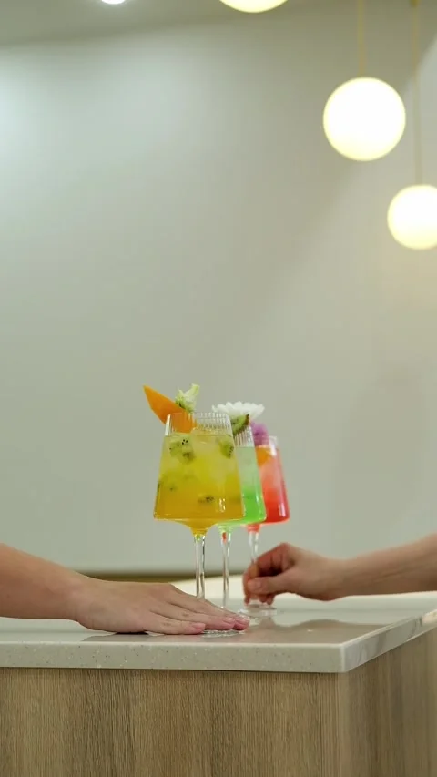 Close-up of hands pulling cocktail glasses towards them, Slow motion. Stock Footage 307273864