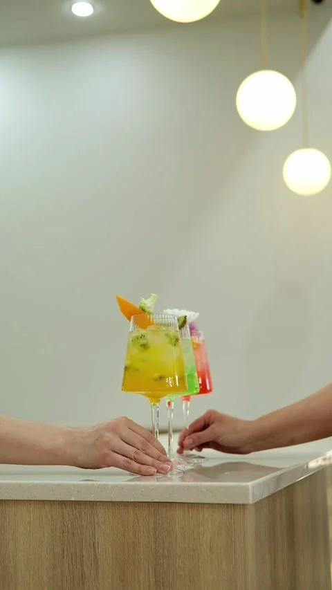 Close-up of hands pulling cocktail glasses towards them, Slow motion. Stock Footage 307274527