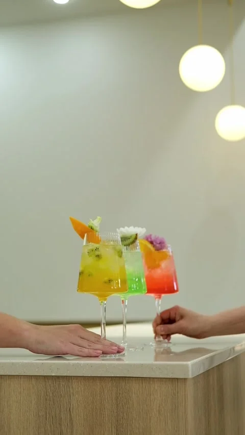 Close-up of hands pulling cocktail glasses towards them, Slow motion. Stock Footage 316578640