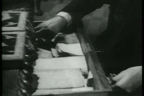 Close-up of hands pulling out map from drawer and unfolding it Stock Footage 11352661