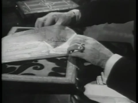 Close-up of hands pulling out map from drawer and unfolding it Stock Footage 260250824