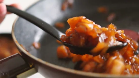 Close up of a hands putting apple flambe into tartlets from pan. Apple crumble Stock Footage 128587279