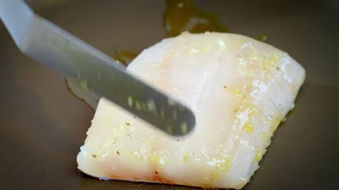 Close-up of hands putting piece of white Fish Fillet on a Pan. Zander fillet. Stock Footage 273983149