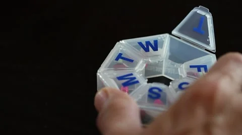 Close up of hands putting pills in container Stock Footage 7824172