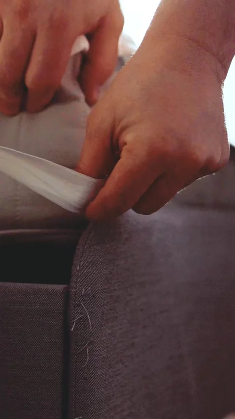 Close up of hands putting on a protective mattress cover corner Stock Footage 341858655