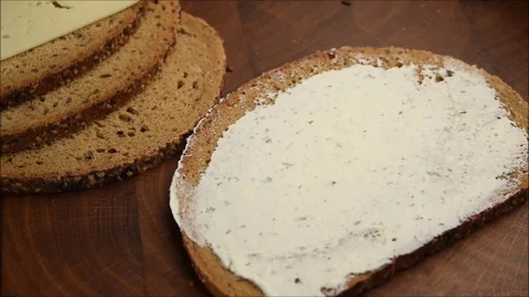 Close up Hands putting Salami on Slice of Whole wheat bread with cream cheese  Stock Footage