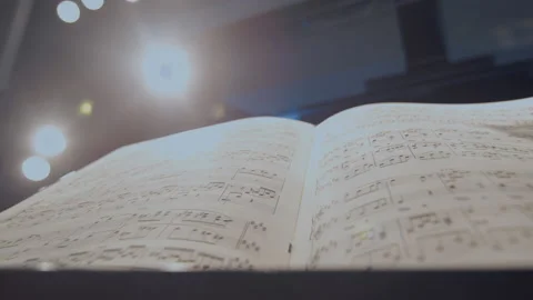 Close-up of hands putting sheet music on the music stand on stage Stock Footage 140742586