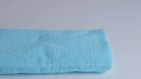 Close-up of hands putting stack of fresh bath towels on the bed sheet. Room Stock Footage 124204816