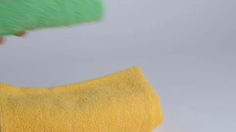 Close-up of hands putting stack of fresh bath towels on the bed sheet. Room Stock Footage 124204869