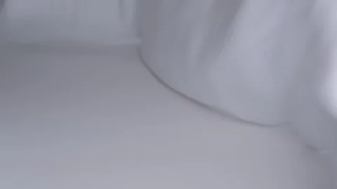 Close-up of hands putting stack of fresh bath towels on the bed sheet. Room Stock Footage 124204999