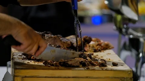 Close up on hands  quickly slicing cooked meat. Stock Footage 95233811