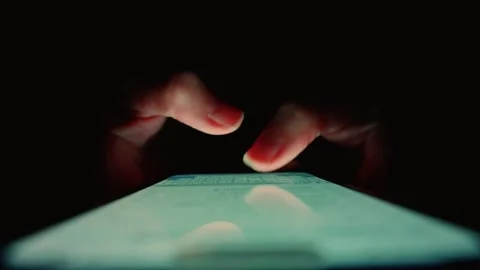 Close-up hands quickly typing text on mobile bright phone screen, light in black Stock Footage 346050535