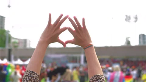 Close up hands raised up with shape of heart for freedom with LGBT pride month. Stock Footage 276734734