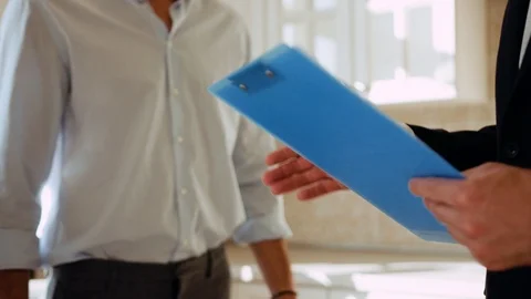 Close up hands real estate agent and young man shake hands and make a deal Stock Footage 114290710