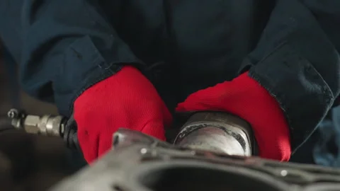Close-Up of Hands in Red Gloves Working on Engine Block in Mechanical Workshop Stock Footage 303064660