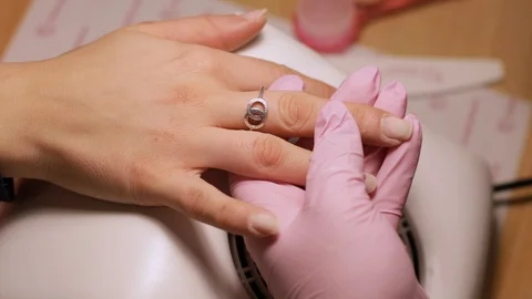 Close up hands removes gel from client nails with electric drill. Stock Footage 121803242