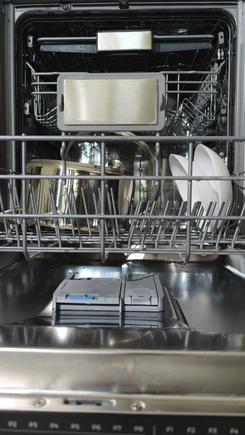 Close up hands removing clean plates from dishwasher lower rack. Person unl.. Stock Footage 344891996