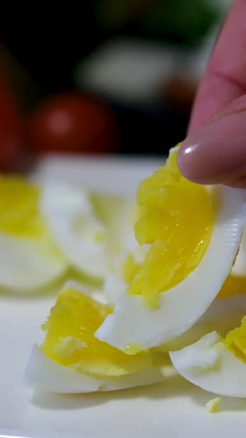Close-up of hands removing the golden shell from a hard-boiled Easter egg Stock Footage 302760981