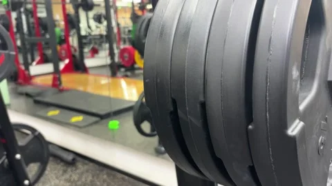 Close Up of Hands Removing Heavy Weight Plate from Gym Rack Stock Footage 329336518