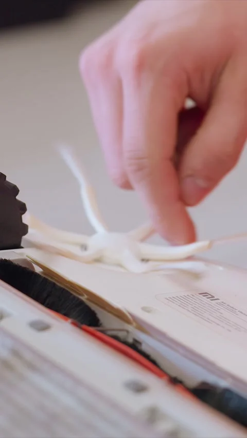 Close up of hands removing plastic parts from electronic device for internal Stock Footage 346787029