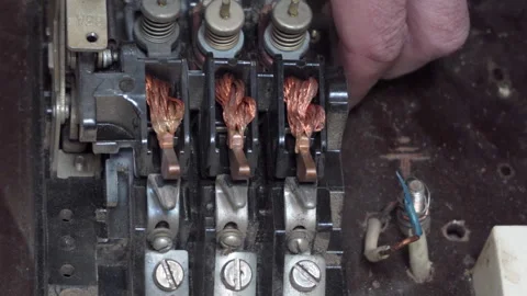Close up of hands repairing retro three-phase electrical contactor mechanism Stock Footage 344950595