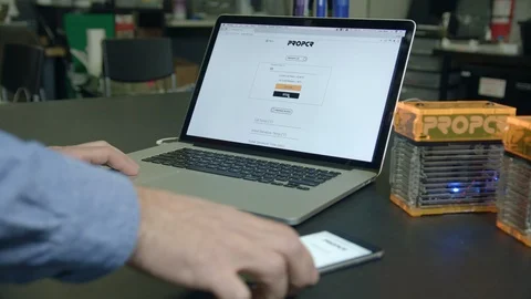 Close-up Hands Of Researcher connecting both cell phone and computer Stock Footage 112160968